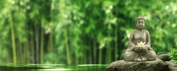 buddha statue on a rock in a blurred green bamboo jungle with smooth water surface, fresh natural spa wallpaper concept with asian spirit and copy space