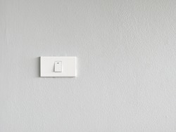 White lighting switchs on concrete wall, Single light switch