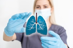 the doctor holds the lungs organ symbol. Awareness of lung cancer, pneumonia, asthma, COPD, pulmonary hypertension, world no tobacco day and eco air pollution. Respiratory and chest concept.