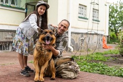 military father meeting with daughter and dogs