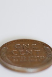 Macro close-up of one cent coin on white background with copy space and narrow depth of field
