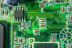 Macro shot of a Circuitboard with resistors microchips and electronic components. Computer hardware technology. Integrated communication processor