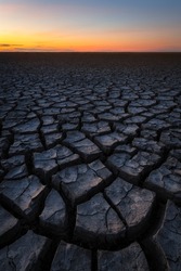 The drought creates beautiful structures in the clay in the Wadden area. Photo was taken after sunset with a beautiful glow on the horizon.