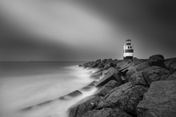 Lighthouse on south pier in Ijmuiden. Photo taken with very long exposre, en convert to black and white. 