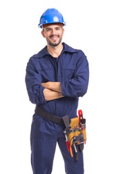 Portrait of a smiling young worker standing with arms crossed on white background
