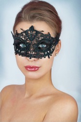Mask.Nude.Girl.Venice carnival mask Close-up female portrait.Blue eyes. Gray background