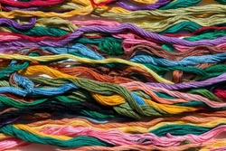 multi-colored threads for embroidery, floss, Mixed colorful texture of interlaced threads