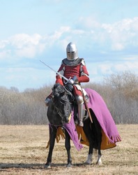 The horse knight with a sword in a hand
