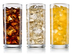 Glasses of sweet carbonated drinks with ice cubes isolated on white. With clipping path