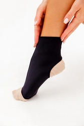 Support for foot injury, ankle brace on white background. Vertical photo