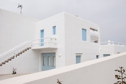 White villa house building facade exterior mediterranean architecture sky background.