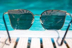 summertime vacation. beach fashion on summertime. sunglasses at swimming pool in summertime.