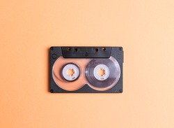 Audio cassette tape on a yellow background. Nostalgia concept.