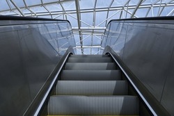 Perspective view of the escalators under the glass roof in the underground station