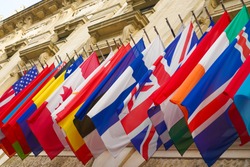 many national flags of different states hang on historical building in Hofburg, Wien. Worldwide, internationa Flags at the HQ of OSCE in Vienna, Austria.