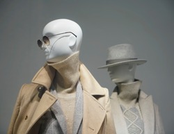 Two female mannequins wear luxury style winter clothes. Female mannequins in shop window. Standing women dummies show casual style collection of clothes in showcase