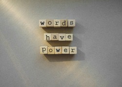 words  Words Have Power written in  wooden alphabet letters isolated on an craft paper - carton background with empty copy space. ray of sunshine.