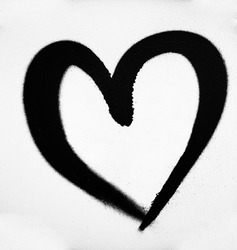 Black heart on white wall background. dark heart painted on gray  wal.l close-up image.