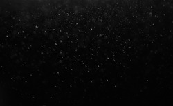 Dark glitter colorful  lights background. light in black background. Dust  in the space. hole in the wall.