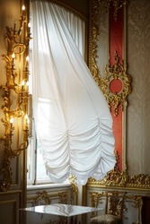 interior view of luxury golden room or hall decorated with gold, nobody. white flying curtain on big window. day light. 