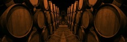 Wine or cognac barrels in the cellar of the winery, Wooden wine barrels in perspective. wine vaults. vintage oak barrels of craft beer or brandy. 