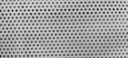 Round hole stamping steel grating, grey color iron material background. Silver gray metal plate with many circular holes. 
