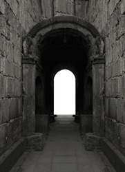 light breaking through at the end of a dark tunnel. Arched entrance through city walls. Entry arch to the old town. christian church. Dilijan, Haghartsin Monastery, Goshavank