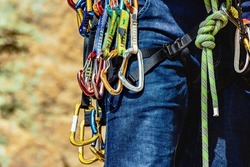 Man in harness and rockclimbing equipment