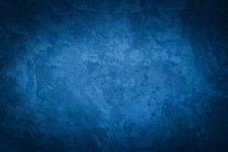 Blue decorative plaster texture with vignette. Abstract grunge background with copy space for design.