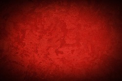 Texture of red decorative plaster or concrete with vignette. Abstract grunge background for design.