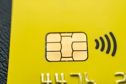 Close-up shot of a debit or credit plastic card with a chip.