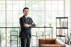 Asian, businessman and office. Portrait of Asian business man wear suit at the office. Smiling Asian business man standing with background modern office