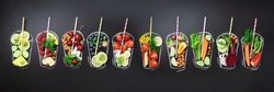 Food ingredients for blending smoothie or juice on painted glass over black chalkboard. Top view with copy space. Organic fruits, vegetables, nuts, seeds. Vegan, detox, clean eating concept.