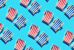 Deck chairs pattern on blue paper background. Flat lay and copy space. Summer travel vacation concept. Creative design, minimal flat lay concept. Minimal composition. Summer time