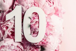 Peony flowers, digit ten. Birthday greeting card with inscription 10. Anniversary concept. Top view. White numeral on flower background. Numerical digit, Celebration event, template, flyer.