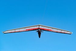 Pilot on modern high performance hang glider. Aviation athlete.