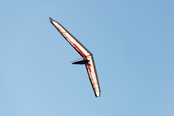 Flying man on modern hang glider wing