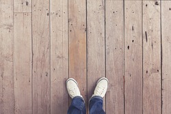white shoes on wooden planked floor from above