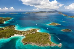 Aerial view of Caneel Bay on the island of St. John with St. Thomas in the distance in the United States Virgin Islands.