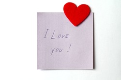 A close up of a sticky note with the word I Love You with red heart. Valentine's Day. Valentine's Day background. I love you lettering text. love concept.