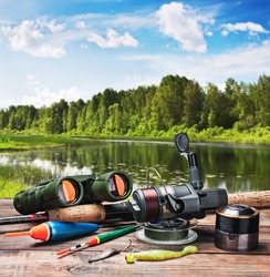 fishing tackle on a pontoon on the background of the lake in the woods