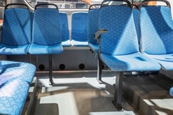 modern and comfortable city bus, an electric bus or a hydrogen bus cabin with suspended empty passenger seats