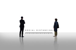 Two people standing keep distance with the word social distancing in between concept, New normal concept, People keeping distance for infection risk and disease Coronavirus.