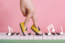 woman hand finger walking on piano between music note with shoe concept, Music lesson school education concept, Dance exercise for good healthy. 