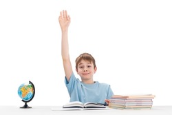 Know-it-all boy raised his hand high in class. Portrait of schoolboy with notebooks and textbook in isolation on white background. Excellent student