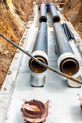 Replacement of heating pipes and modernization of the heating system. Construction works on large iron pipes at a depth of excavated trench. Carrying out construction and repair work in the city