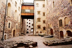 Walk way between building and pattern of windows at Turku castle.  Medieval building in the city of Turku in Finland. It was founded in the late 13th century and stands on the banks of the Aura River