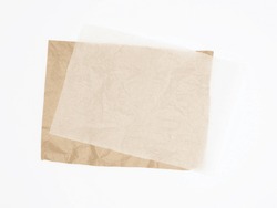 Abstract brown recycled crumpled paper and crumpled tracing paper isolated on white background.