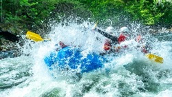 Group of people doing whitewater rafting in the pure nature of Scandinavia