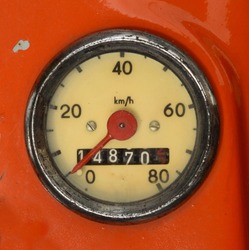 A Vintage Speedometer On A Red Scooter